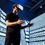 A professional male performer in modest, futuristic performance attire, wearing a sleek virtual reality headset, interacting with AI-generated holographic projections that depict dynamic abstract shapes and patterns. The performance takes place inside a repurposed, modern industrial building with high ceilings and clean, minimalist design, illuminated by programmable LED lights. The ambiance is cutting-edge and immersive, showcasing the integration of advanced technology in live art. The performer maintains a natural pose with perfect anatomy and correct proportions, featuring well-formed hands and proper finger count. safe for work, appropriate content, fully clothed, professional performance, high quality, cinematic lighting.